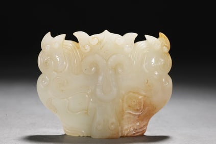 A Qing Dynasty Hetian white jade belt with a beast face pattern buckle