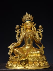 A green Tara statue painted in copper gilts