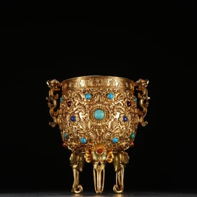 A fine copper-gilt three-legged permanent cup