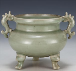 A three-legged incense burner with fish ears in the kiln of Longquan in the Song Dynasty