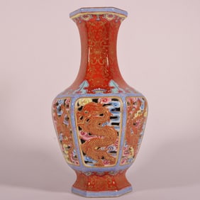A Qing Dynasty Qianlong year alum red carved gold-painted dragon and phoenix hollow hexagonal vase