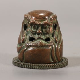 A beautifully carved copper aroma burner