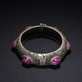 A Qing Dynasty sterling silver ruby-inlaid bat pattern bracelet