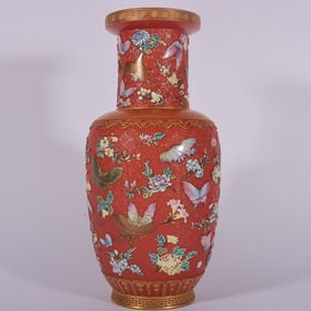 A Qing Dynasty Qianlong year alum red carved butterfly mallet bottle