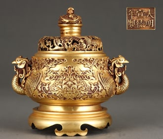 A piece of Ming Dynasty copper gilt peony pattern phoenix head ear smoker
