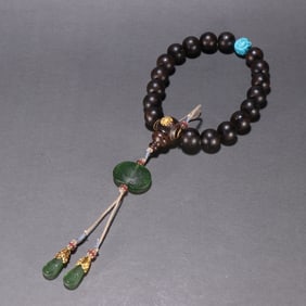 A piece of agarwood from the Qing Dynasty is held