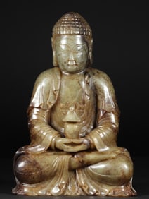 A seated statue of Shakyamuni Buddha made of Hetian jade seed material in the Ming Dynasty