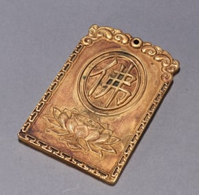A beautiful copper-gilt amulet