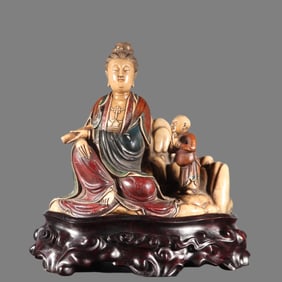 A statue of Shoushan stone boy worshiping Guanyin