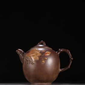 A purple sand magnolia pattern teapot by Jiang Rong