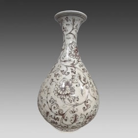 A Ming Dynasty glazed red rolled lotus pattern jade pot spring vase