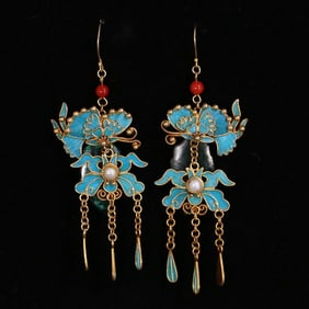 A pair of coral horn earrings from the Qing Dynasty court with silver gilt filigree dotted emeralds