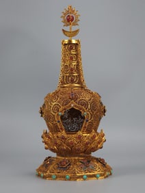 A stupa with copper gilt filigree