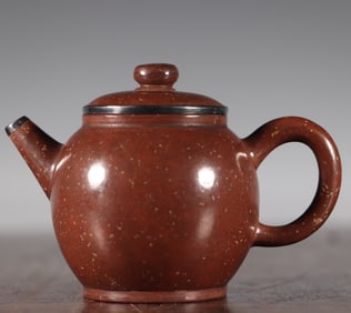 A silver-mouthed purple clay pot