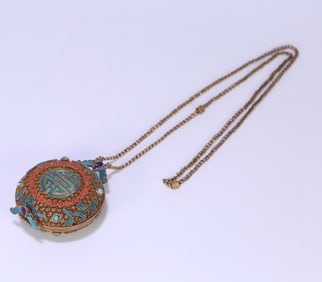 A Qing Dynasty silver-gilt filigree dotted emerald inlaid Fushou sachet inlaid with coral turquoise