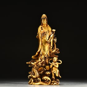 A beautifully gilded boy worships Guanyin