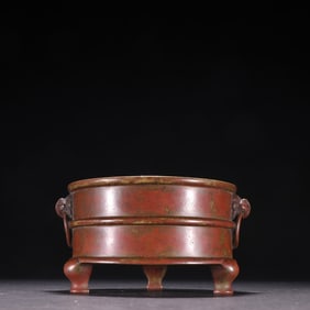A Xuande model copper tire date red leather lion face auxiliary ear incense burner
