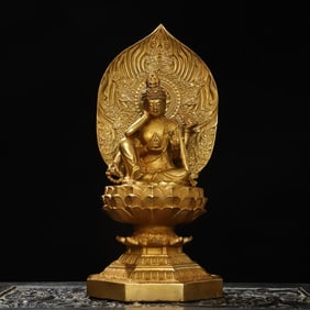A bronze gilt six-armed Guanyin statue
