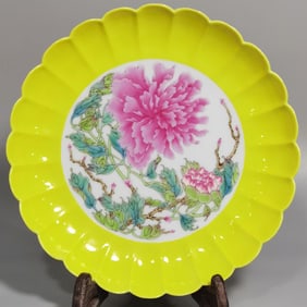A Qing Dynasty Qianlong pastel peony flower yellow glazed melon prism plate