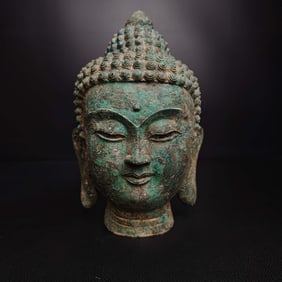 A bronze pineapple head Buddha head