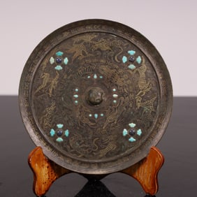 A Han Dynasty Cuo gold and silver turquoise bronze mirror