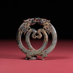 A delicate lacquer painted double dragon jade pendant