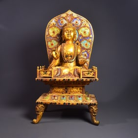 A bronze gilt multi-treasure inlaid Buddha statue