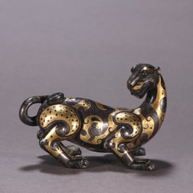A Han bronze gold and silver beast ornament
