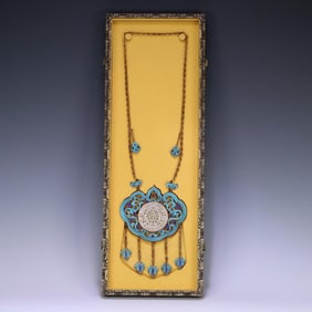 A Qing Dynasty court silver-gilt filigree dotted emerald inlaid Hetian jade lock