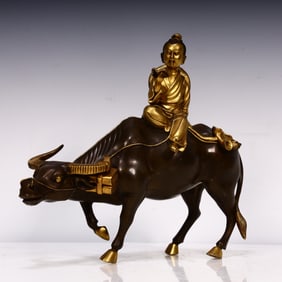 A Qing Dynasty bronze boy riding a bull