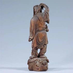 A statue of a Qing Dynasty agarwood carving bangs playing with a golden toad
