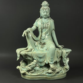 A celadon Guanyin seated statue