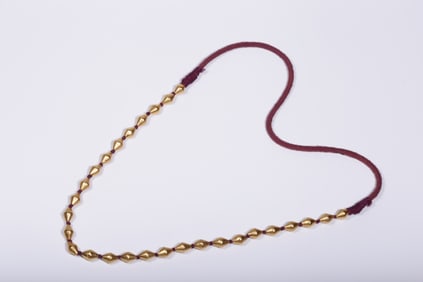 A high-quality solid gold leather-wrapped cinnabar necklace