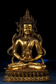 A statue of a longevity Buddha with copper gilt inlaid treasures