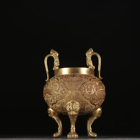 A Qing Dynasty copper-gilt engraved dragon pattern three-legged incense burner