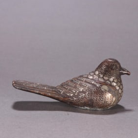 A Han bronze mistake gold and silver black bird staff head