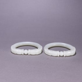 A pair of Qing Dynasty Hetian jade dragon biting bead bracelets