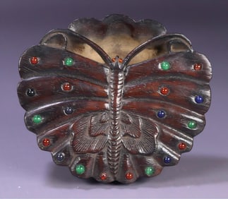 A piece of rosewood inlaid with gemstones and butterfly wash