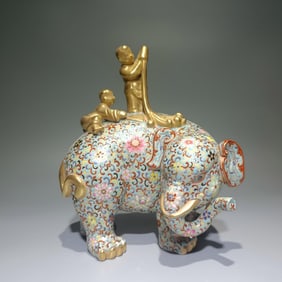 A Qing Qianlong porcelain cloisonné boy elephant ornament