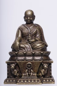 A seated statue of a silver guru in a Qing Dynasty alloy copper file