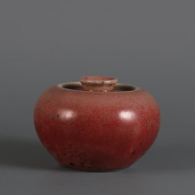 A piece of cowpea red glaze apple made in the Kangxi period of the Qing Dynasty