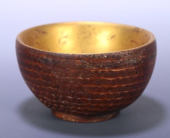 A bamboo root carved lacquered gold bowl