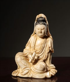 A Qing Dynasty Shoushan stone white hibiscus carved Guanyin seated statue holding scriptures