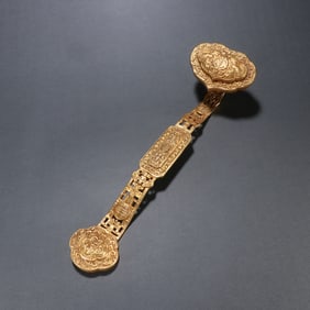 A copper gilt blessing is in front of the wishful handle