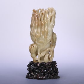 A Qing Dynasty rosewood support Hetian jade Buddha hand flower arrangement