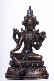 A seated statue of Tara in a bronze inlaid silver green in the Qing Dynasty