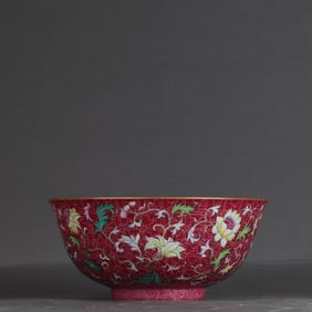 A Qing Qianlong pastel carmine ground rolling flower bowl