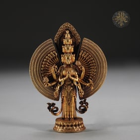 A Ming Dynasty bronze bear gilt thousand-handed Guanyin statue