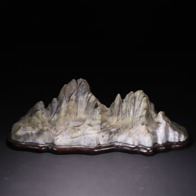 An old jade mountain ornament with a base
