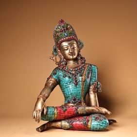 A copper-inlaid white Tara Buddha statue